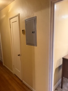 Hallway with two white closed doors and electrical outlet on beige wall
