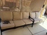 Beige upholstered sofa with black wooden frame in showroom display